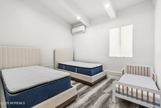 a bedroom with two beds and a night stand