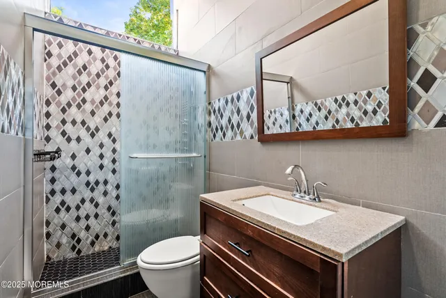 a bathroom with a sink toilet and a mirror