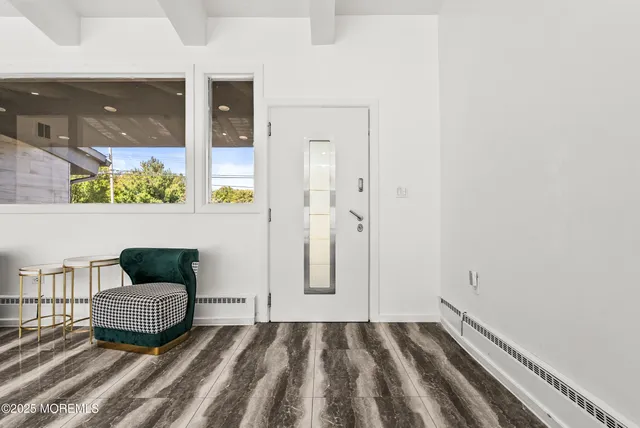 a view of a bedroom with wooden floor