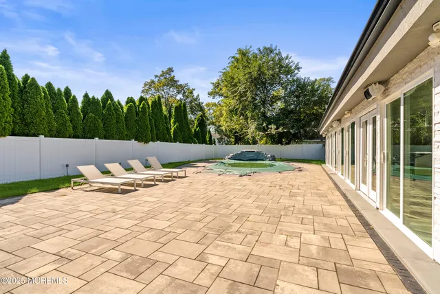 a backyard of a house with yard and outdoor seating