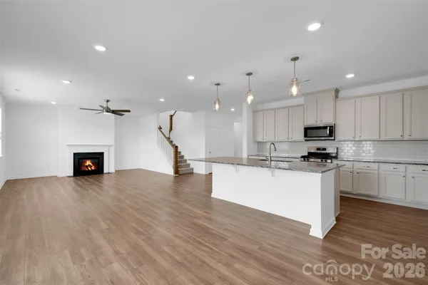 a kitchen with kitchen island a stove a sink and a refrigerator