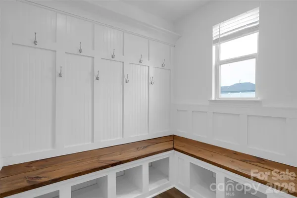a view of a room with wooden floor and staircase