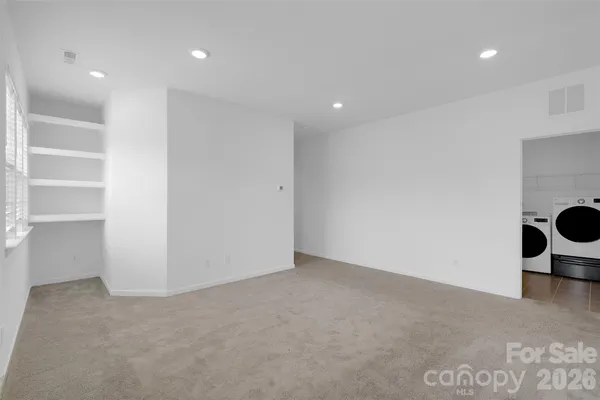 a view of a big room with wooden floor and cabinets