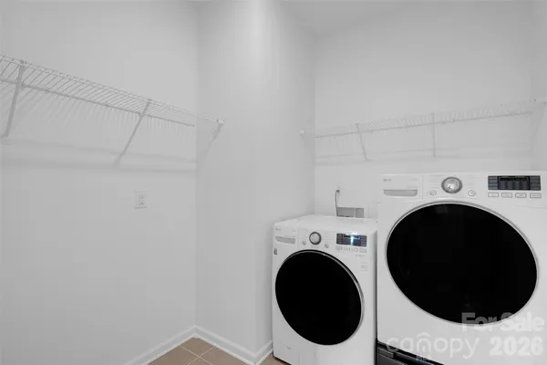 a close view of a utility room with dryer and washer
