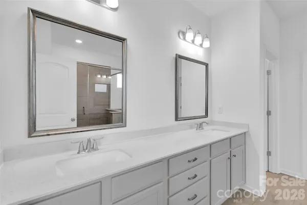 a bathroom with double vanity sinks and a mirror
