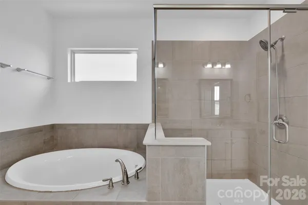a bathroom with a tub and shower