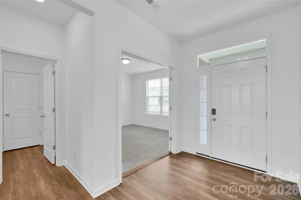 a view of an empty room and wooden floor