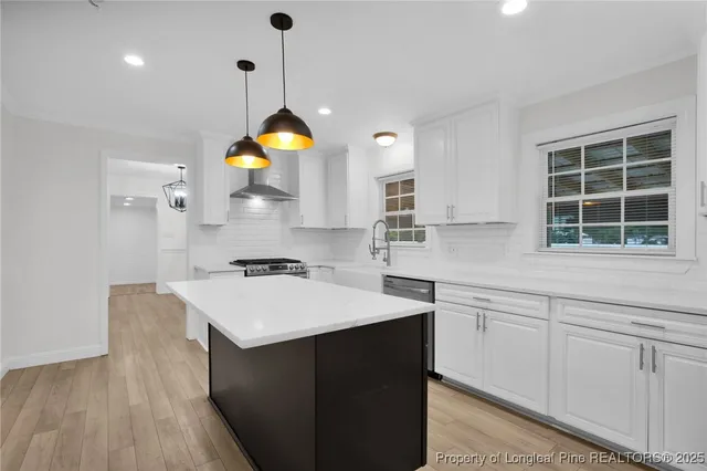 a kitchen with a sink and a stove top oven