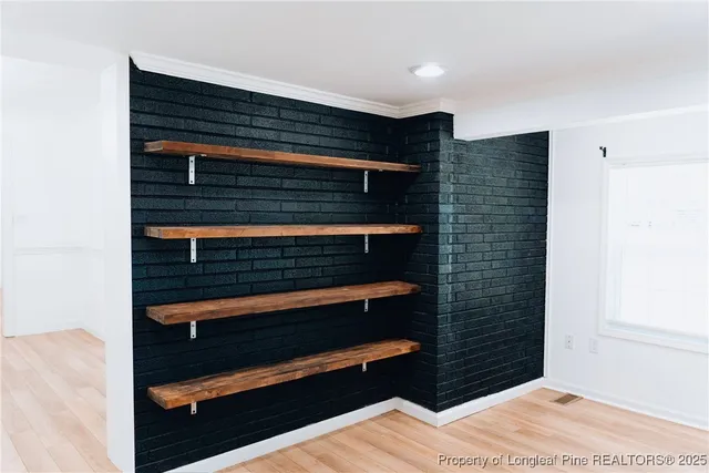 a view of bedroom and wooden floor