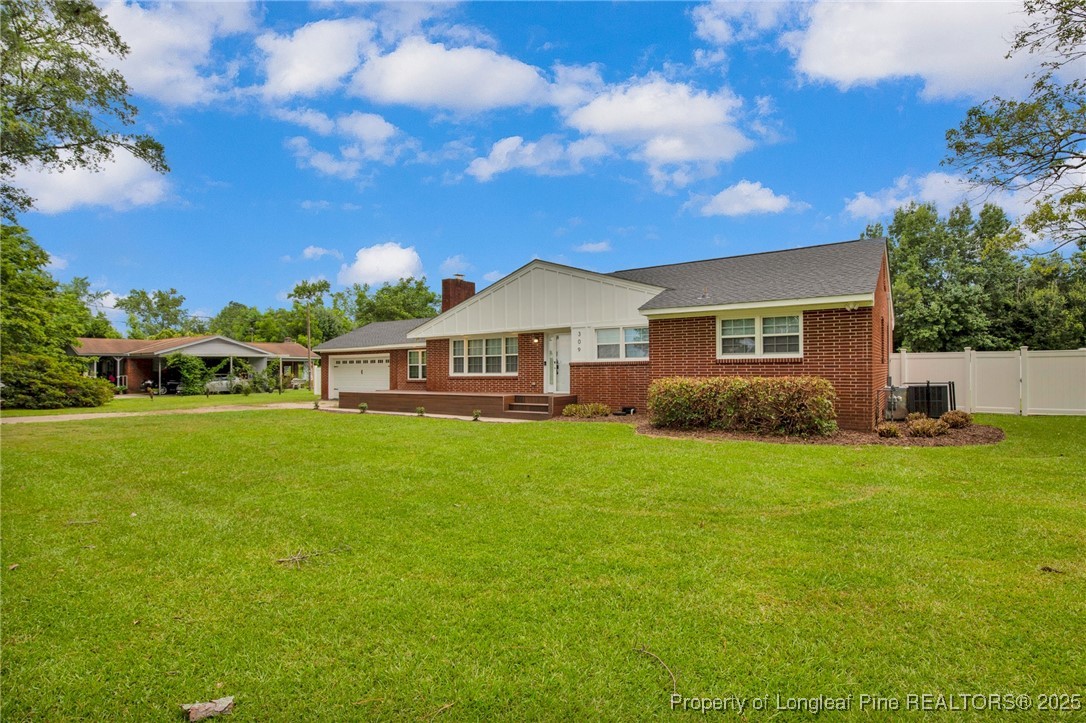 309 Cornith Road Pembroke, NC 28372 - Photo 3 of 40 a front view of a house with garden