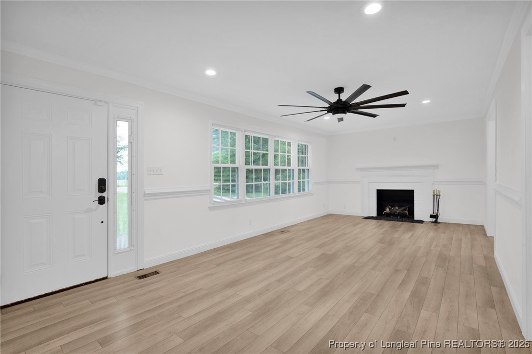309 Cornith Road Pembroke, NC 28372 - Photo 7 of 40 a view of an empty room with a fireplace and a window