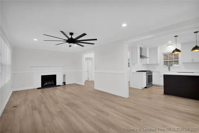 a view of a kitchen with a sink and a fireplace