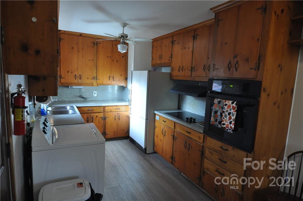 1234 Saluda Road Chester, SC 29706 - Photo 12 of 19 a kitchen with stainless steel appliances granite countertop a sink dishwasher stove and refrigerator with wooden floor