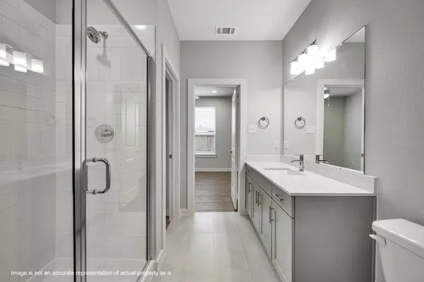 a bathroom with a double vanity sink mirror and shower