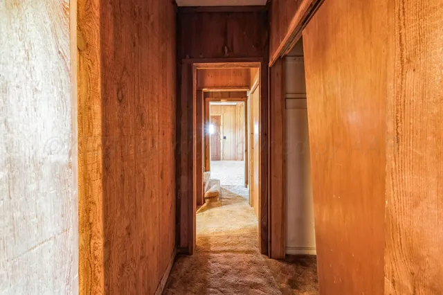a view of staircase with railing and white walls