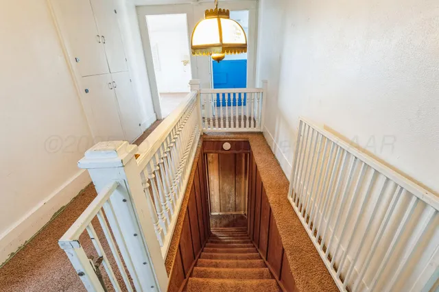 an empty room with windows and entrance