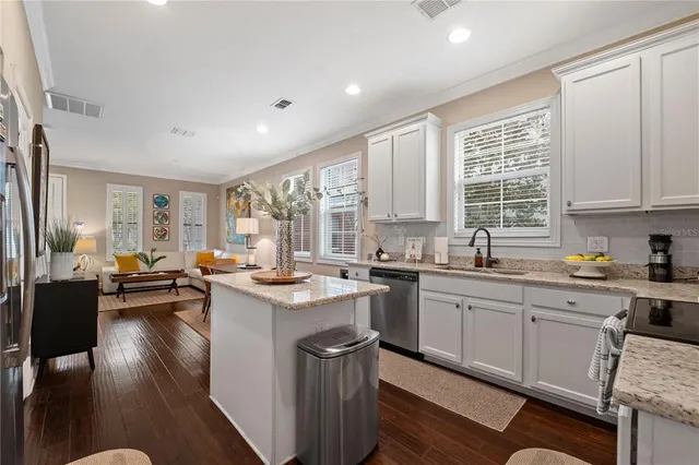a kitchen with sink stove and cabinets