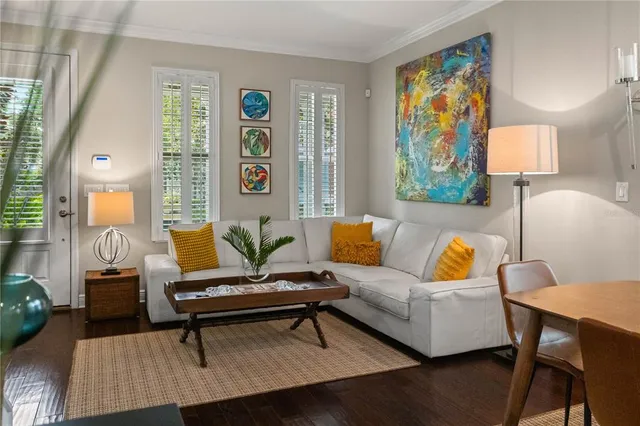 a living room with furniture a rug and a window