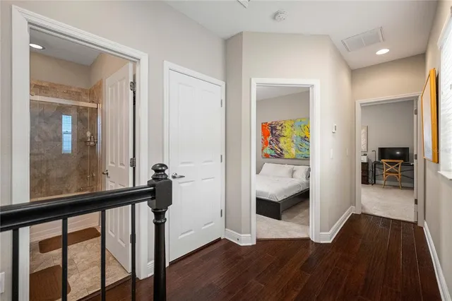 a view of a hallway view with wooden floor and staircase