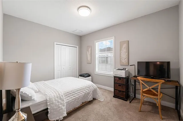 a bedroom with a bed and a chair