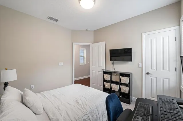 a bedroom with a bed and a television