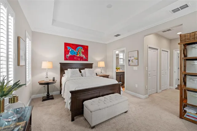 a room with a bed and a painting on the wall