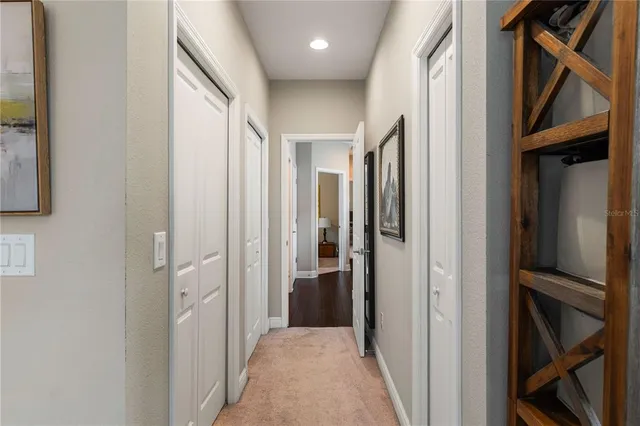 a view of hallway with bathroom