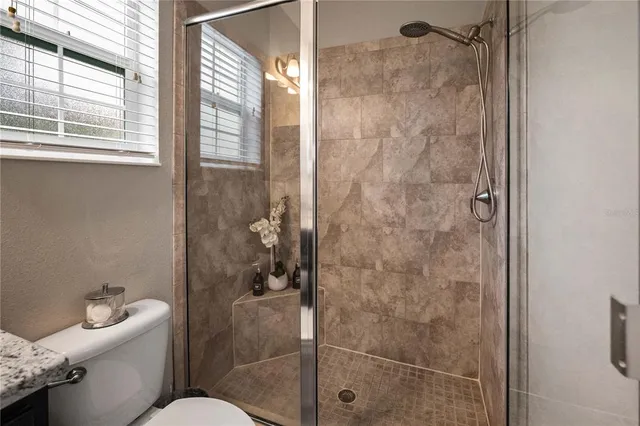 a bathroom with a toilet and shower