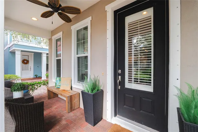 a living room with furniture and a potted plant