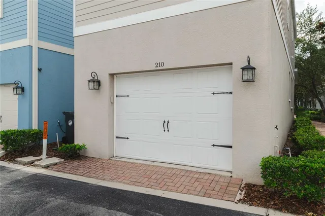 an aerial view of a house with a garden and parking space