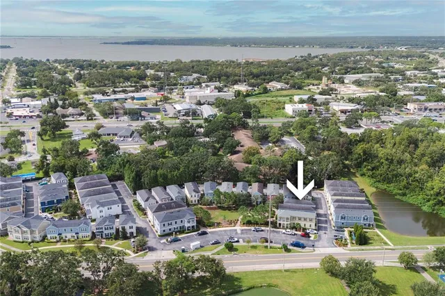 an aerial view of residential house with outdoor space and lake view