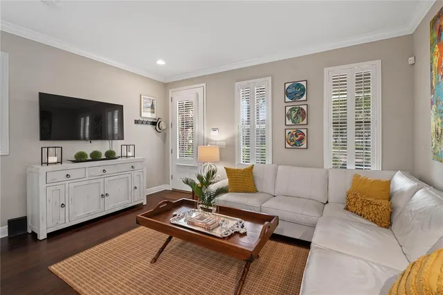 a living room with furniture flat screen tv and window