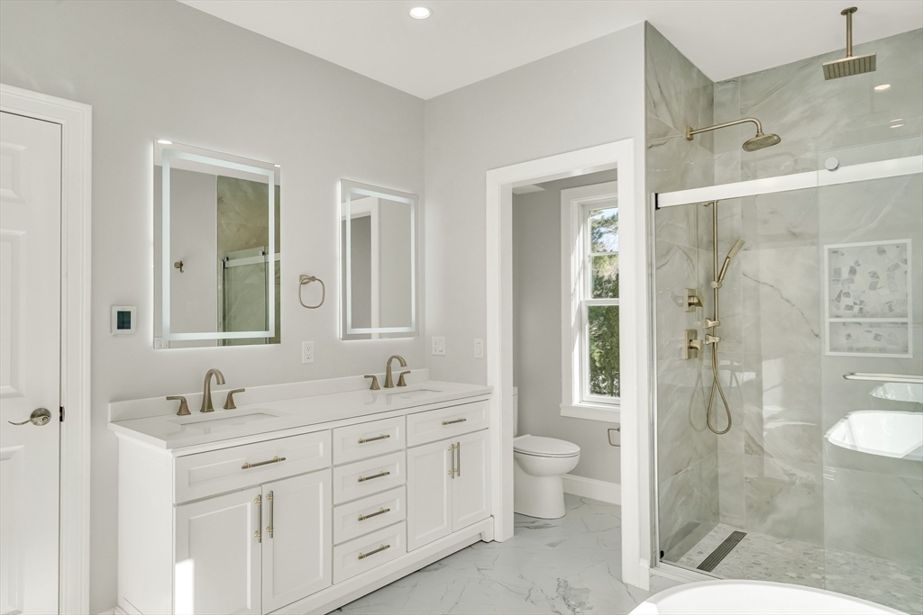 510 Common Street Walpole, MA 02081 - Photo 12 of 35 a bathroom with a double vanity sink toilet mirror and shower