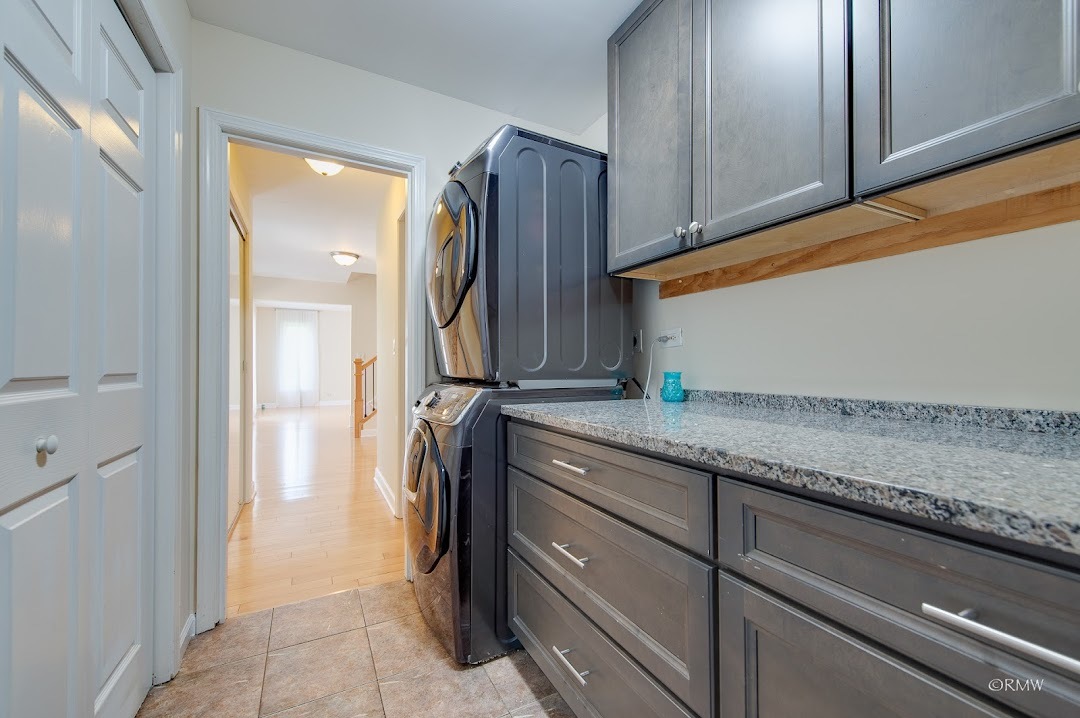 769 Halbert Lane Inverness, IL 60010 - Photo 18 of 48 a bathroom with a granite countertop sink and washing machine