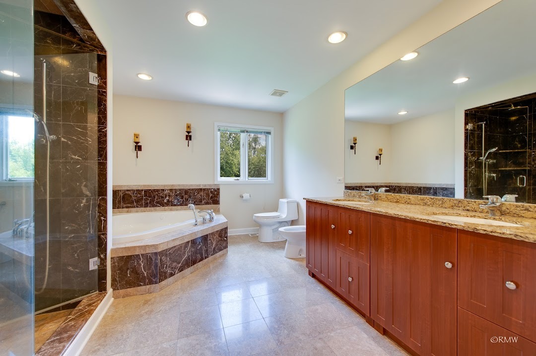 769 Halbert Lane Inverness, IL 60010 - Photo 29 of 48 a large bathroom with a double vanity sink a large mirror and a bathtub