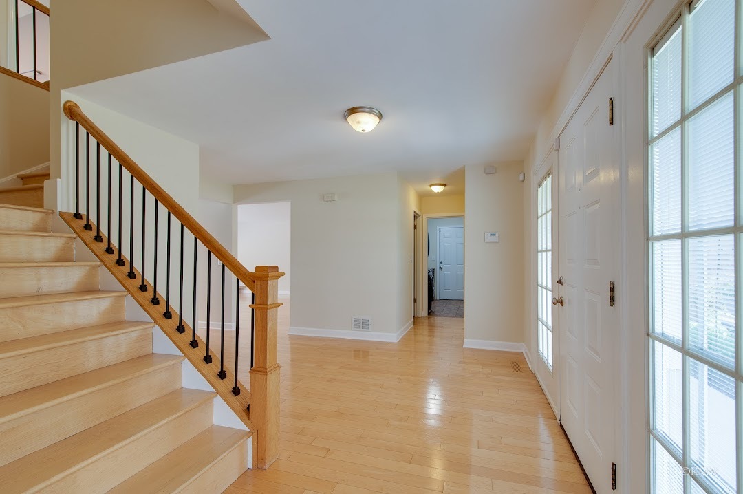 769 Halbert Lane Inverness, IL 60010 - Photo 5 of 48 a view of a hallway with wooden floor and staircase