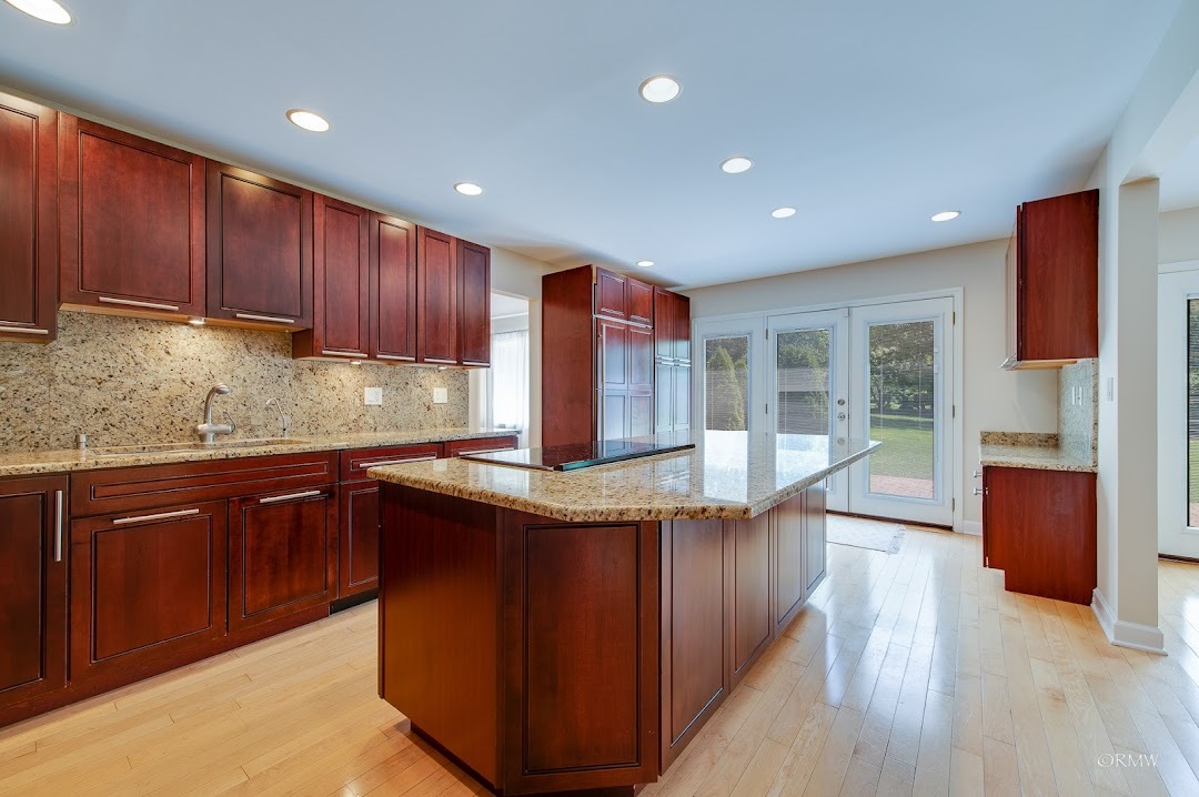 769 Halbert Lane Inverness, IL 60010 - Photo 9 of 48 a kitchen with kitchen island granite countertop wooden floors wooden cabinets a sink and appliances