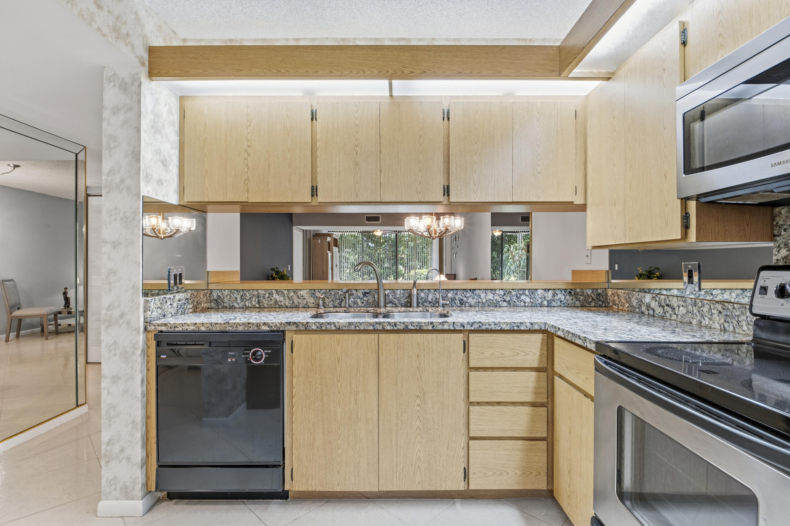 6145 Balboa Circle, Unit 103 Boca Raton, FL 33433 - Photo 5 of 31 a kitchen with a sink and a stove top oven