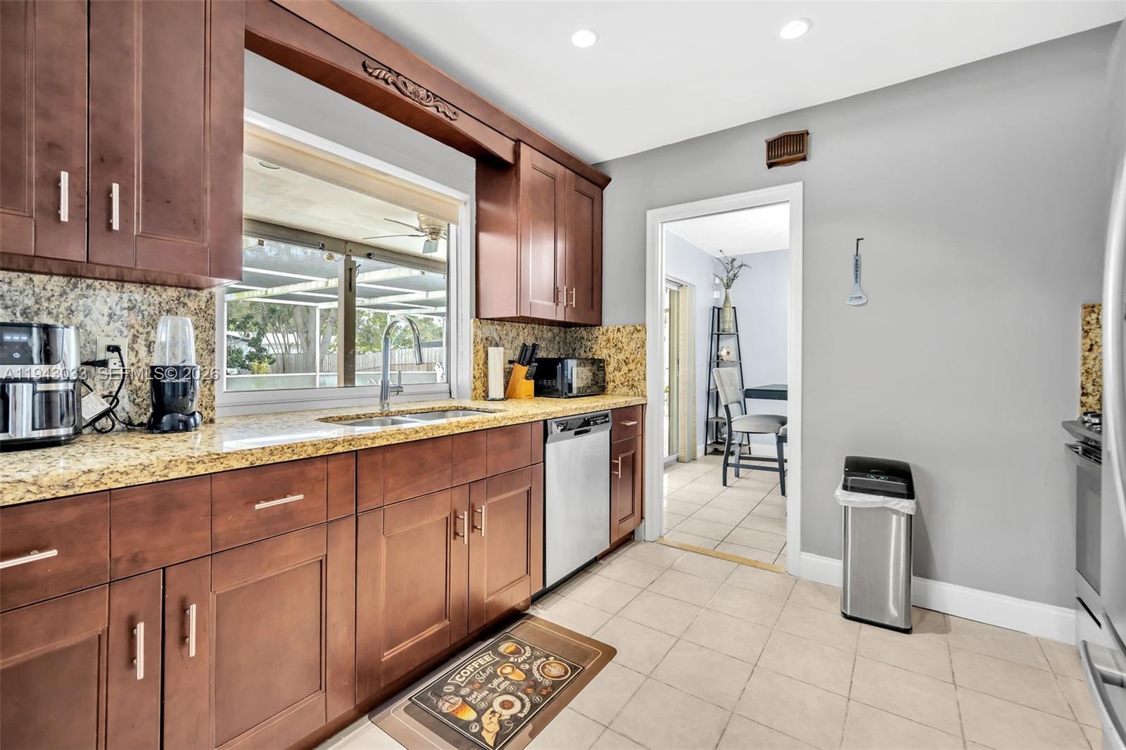2211 North 50th Avenue Hollywood, FL 33021 - Photo 11 of 45 a large kitchen with a large window and stainless steel appliances