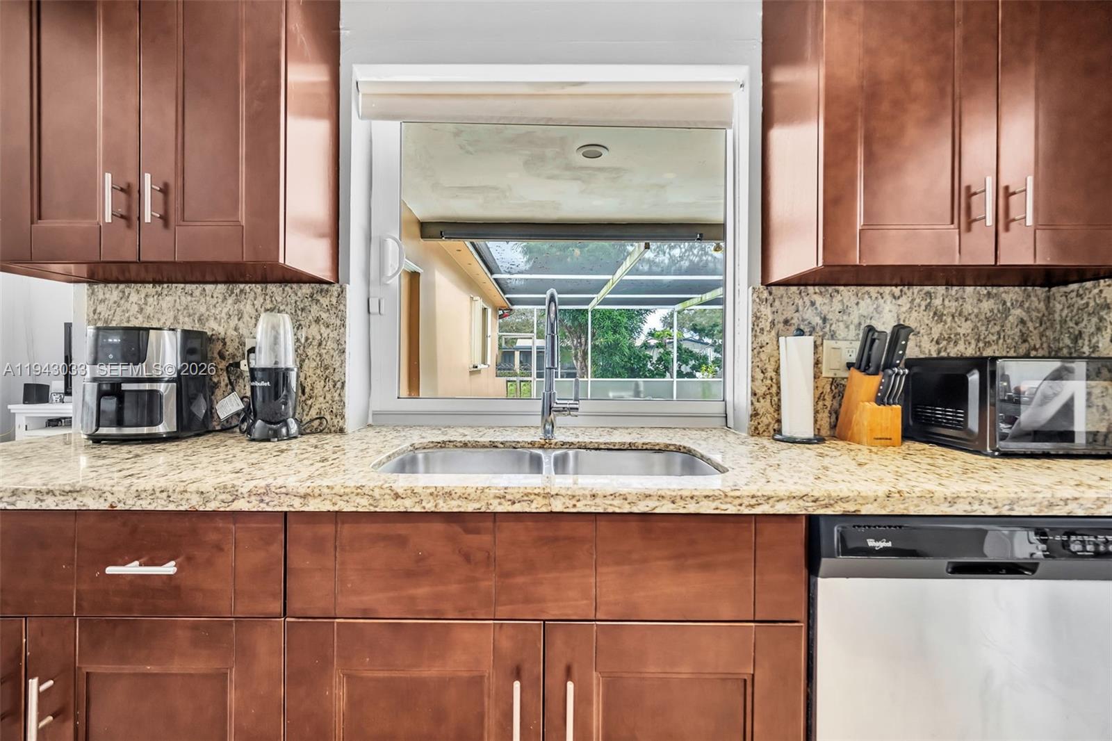 2211 North 50th Avenue Hollywood, FL 33021 - Photo 12 of 45 a kitchen with granite countertop a sink and a stove