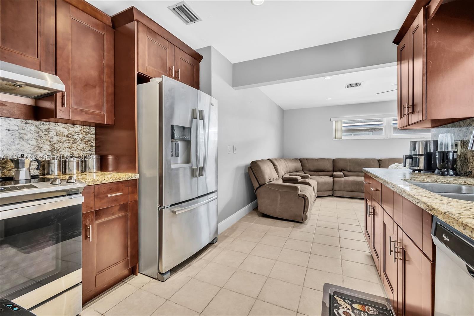 2211 North 50th Avenue Hollywood, FL 33021 - Photo 13 of 45 a kitchen with stainless steel appliances granite countertop a refrigerator a sink a stove and cabinets