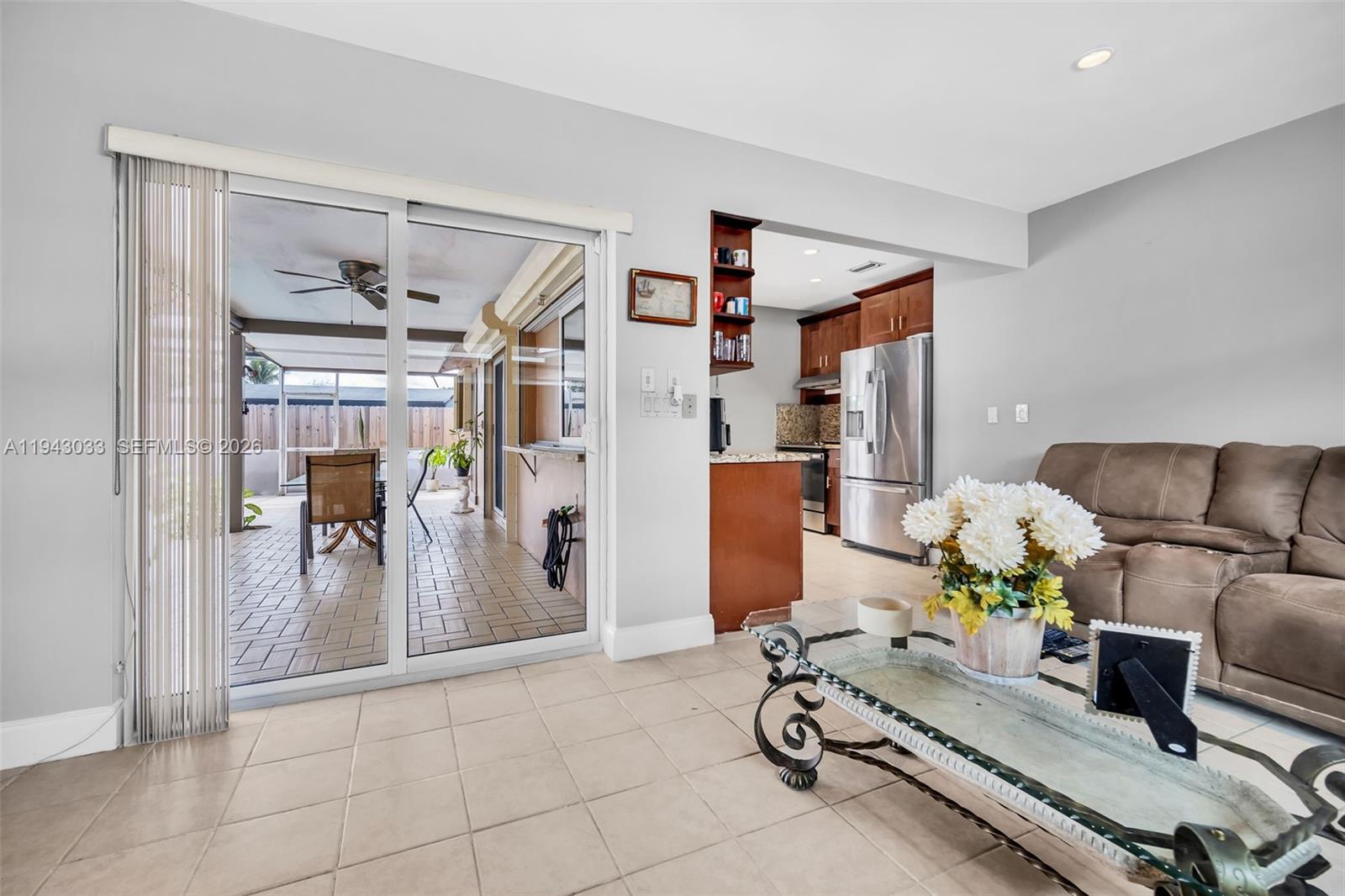 2211 North 50th Avenue Hollywood, FL 33021 - Photo 14 of 45 a living room with furniture gym equipment and a chandelier