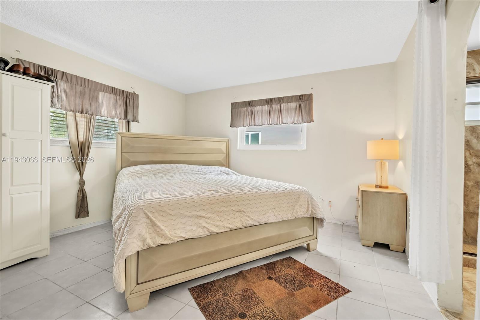 2211 North 50th Avenue Hollywood, FL 33021 - Photo 29 of 45 a bedroom with a bed and dresser