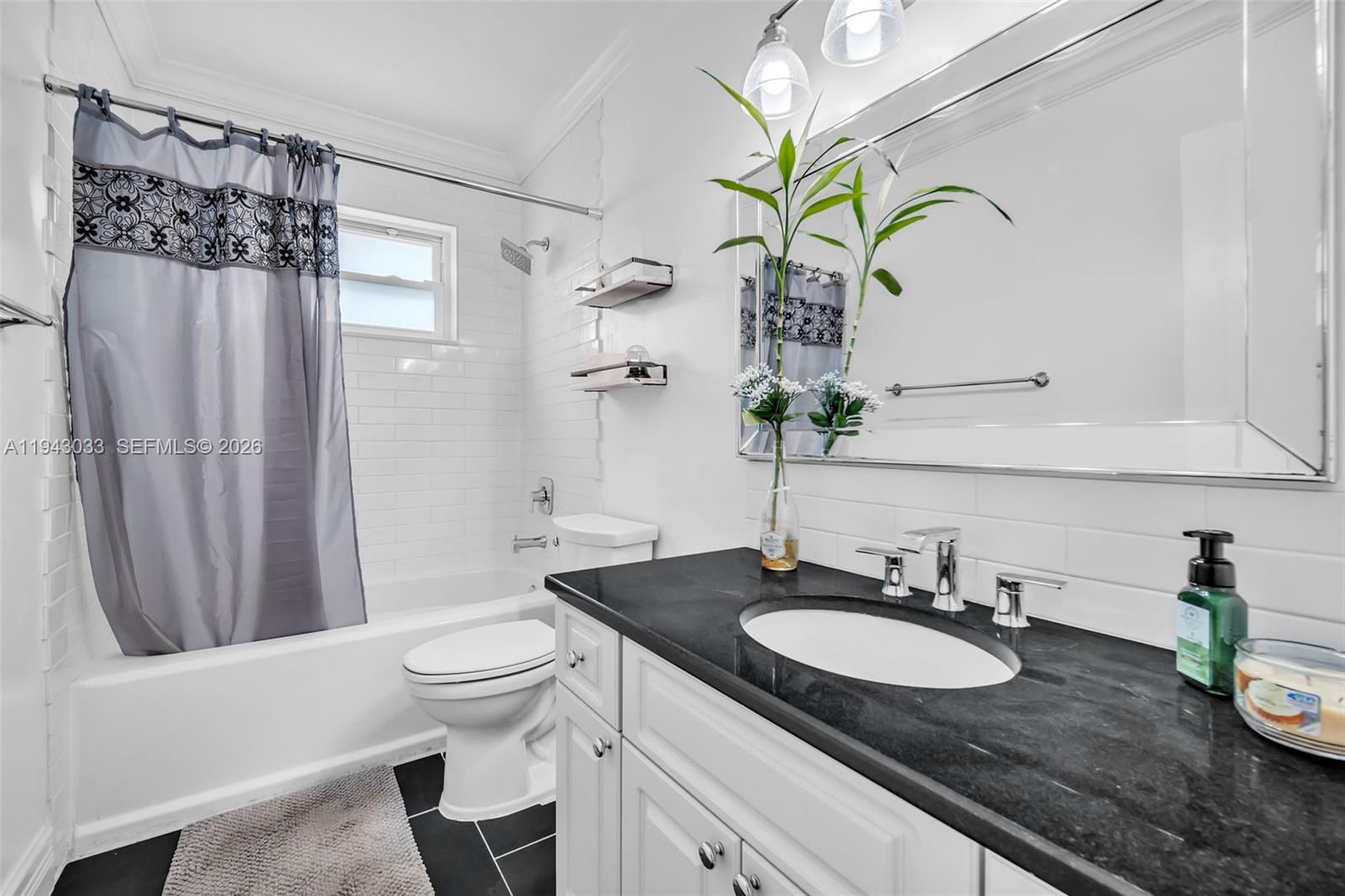 2211 North 50th Avenue Hollywood, FL 33021 - Photo 31 of 45 a bathroom with a granite countertop sink a toilet and a mirror