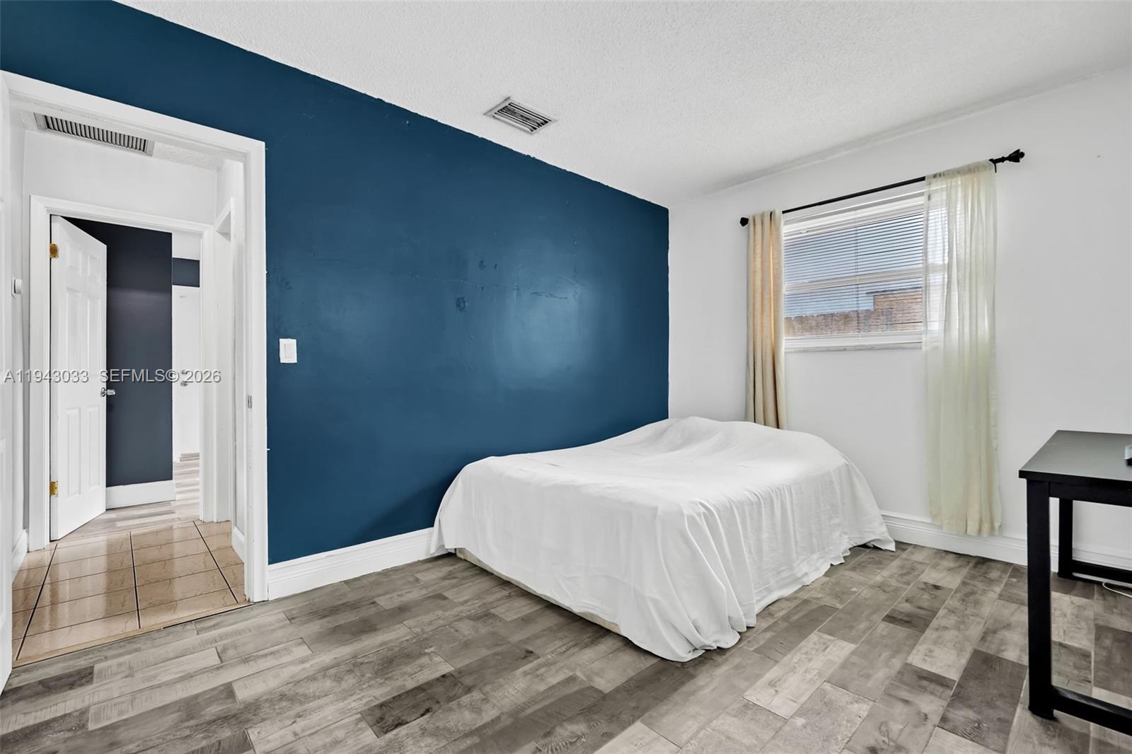 2211 North 50th Avenue Hollywood, FL 33021 - Photo 32 of 45 a bedroom with a bed and a painting on the wall