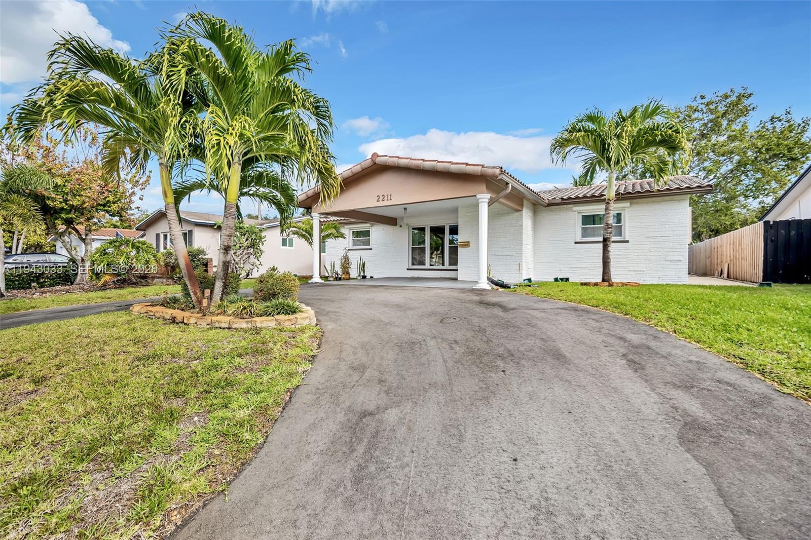 2211 North 50th Avenue Hollywood, FL 33021 - Photo 36 of 45 a front view of a house with a yard and potted plants