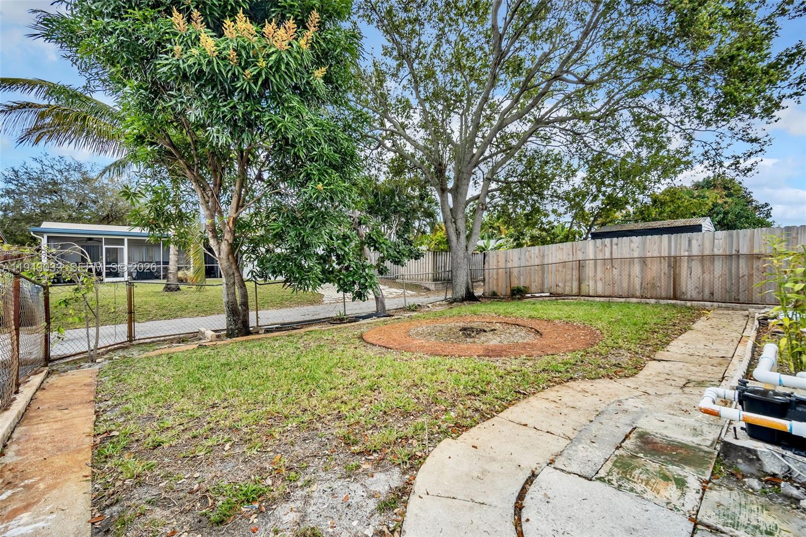 2211 North 50th Avenue Hollywood, FL 33021 - Photo 40 of 45 a view of a backyard with table and chairs and a large tree