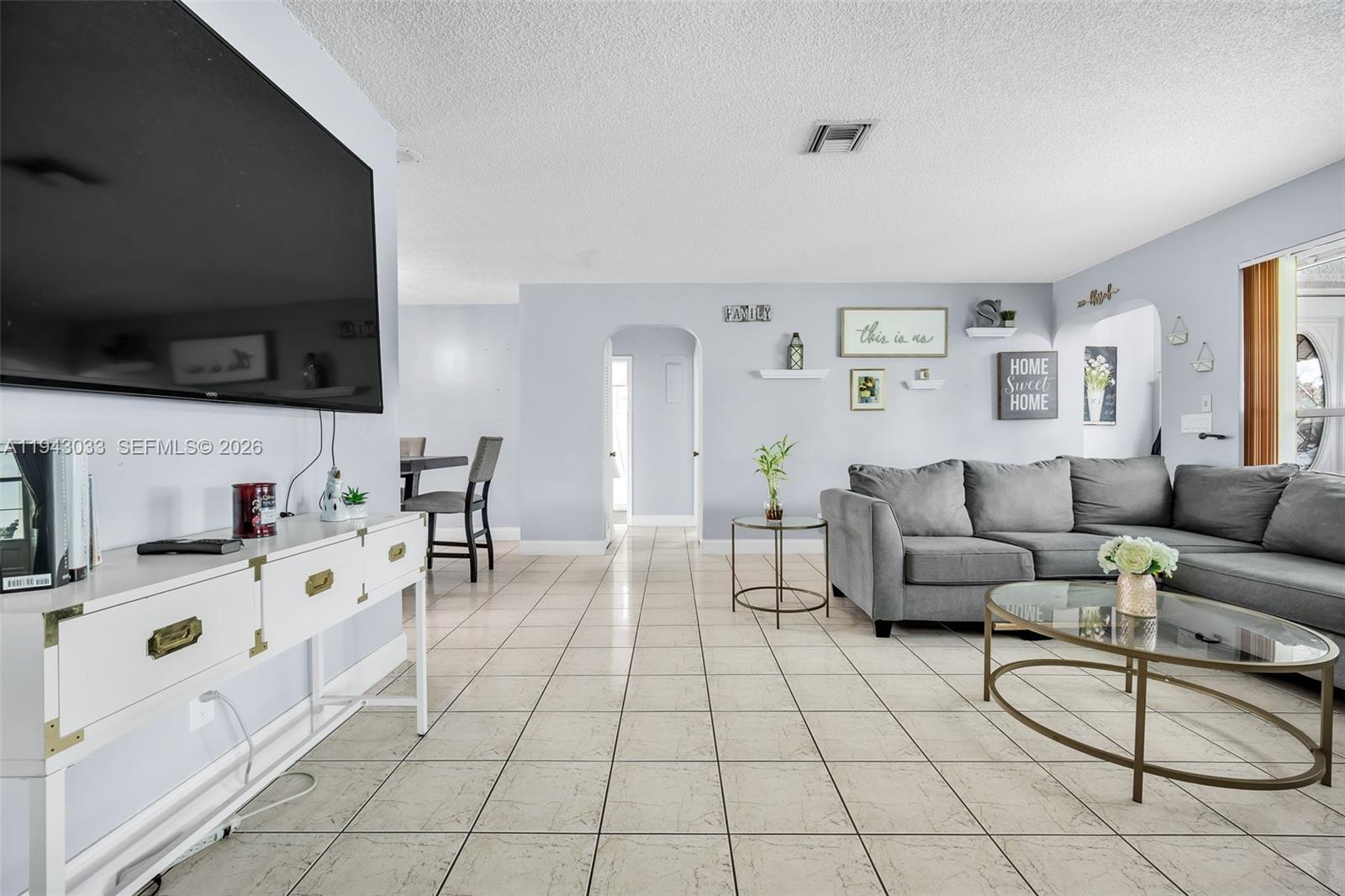 2211 North 50th Avenue Hollywood, FL 33021 - Photo 5 of 45 a living room with furniture and a flat screen tv
