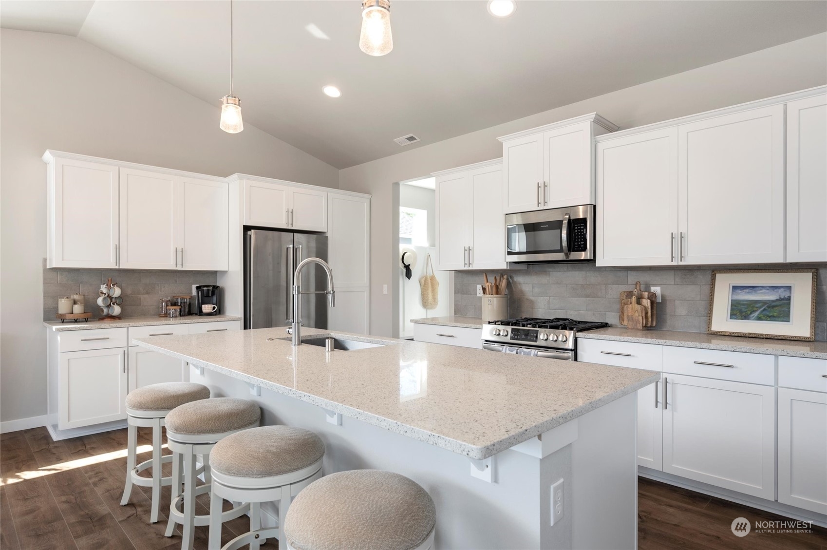 984 Rainier Loop Mount Vernon, WA 98274 - Photo 13 of 40 a kitchen with a refrigerator a stove a sink and white cabinets