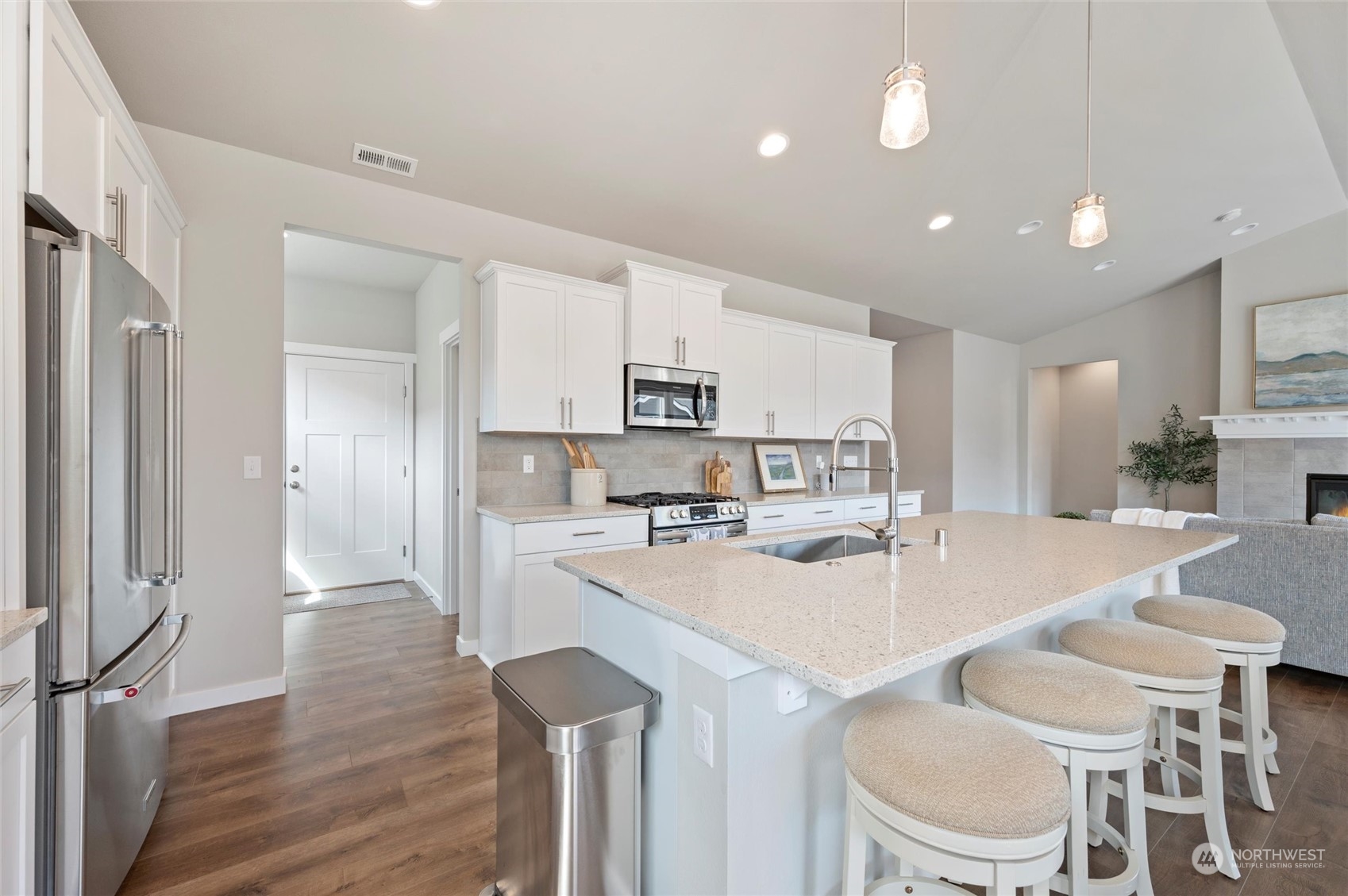 984 Rainier Loop Mount Vernon, WA 98274 - Photo 15 of 40 a kitchen with a dining table chairs refrigerator and cabinets